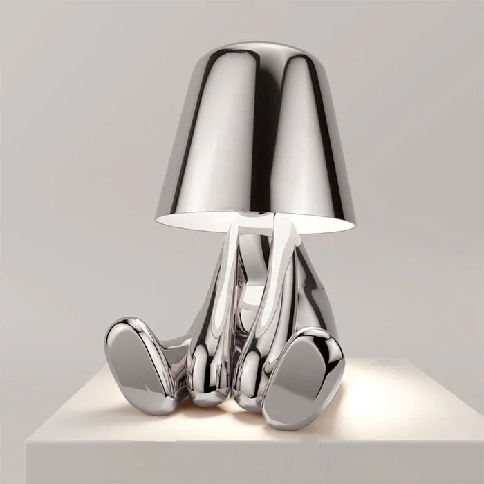 Designerska lampa stołowa LED siedzący człowiek z połyskującym wykończeniem